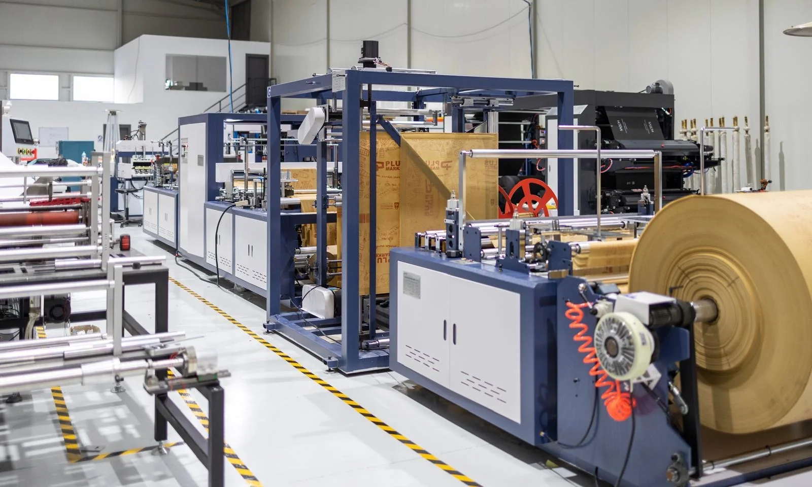 Inside the Kobags production facility: machinery and rolls of non-woven material